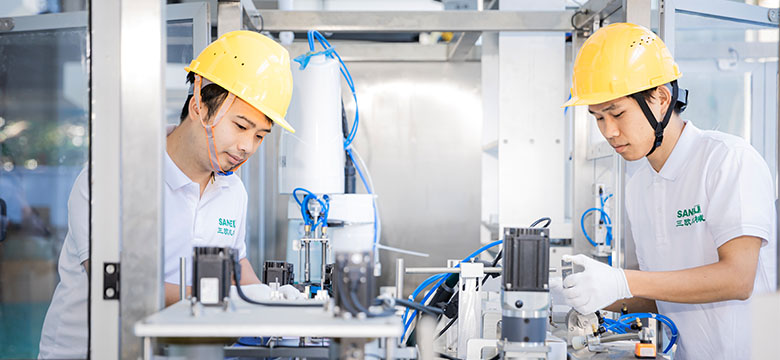 two technicians checking different components of the coffee filling machine