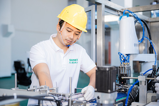 technician checking each part of the coffee filling machine and calibrating the assembly