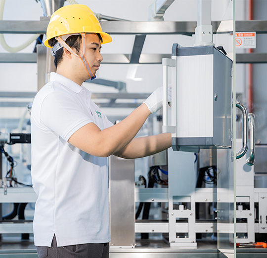 technician checking the calibration of the filling machine's interface