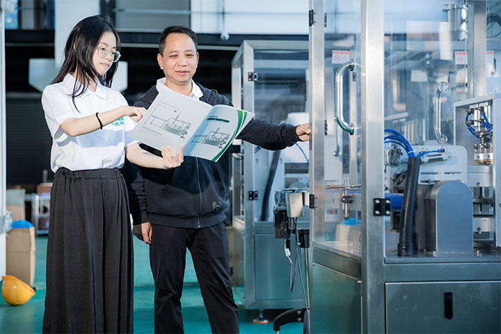 Saneu employee showing a senior technician details on a product manual 2