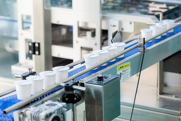 three groups of four coffee pods running along the production line 2