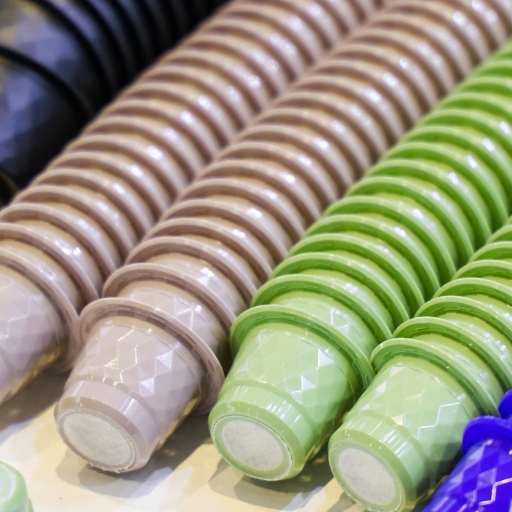 stacks of empty nespresso coffee cups in different colors