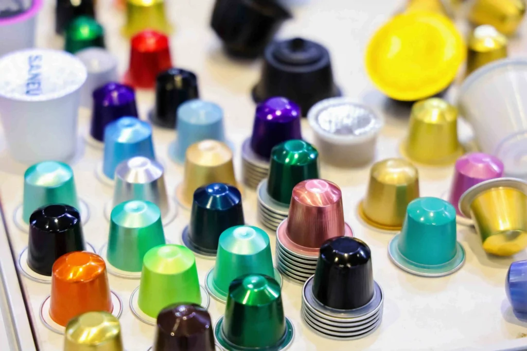colorful array of empty coffee capsules in various colors