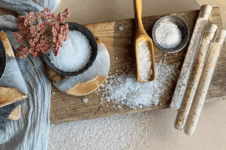 different types of salts displayed on various bowls and in three sealed vials